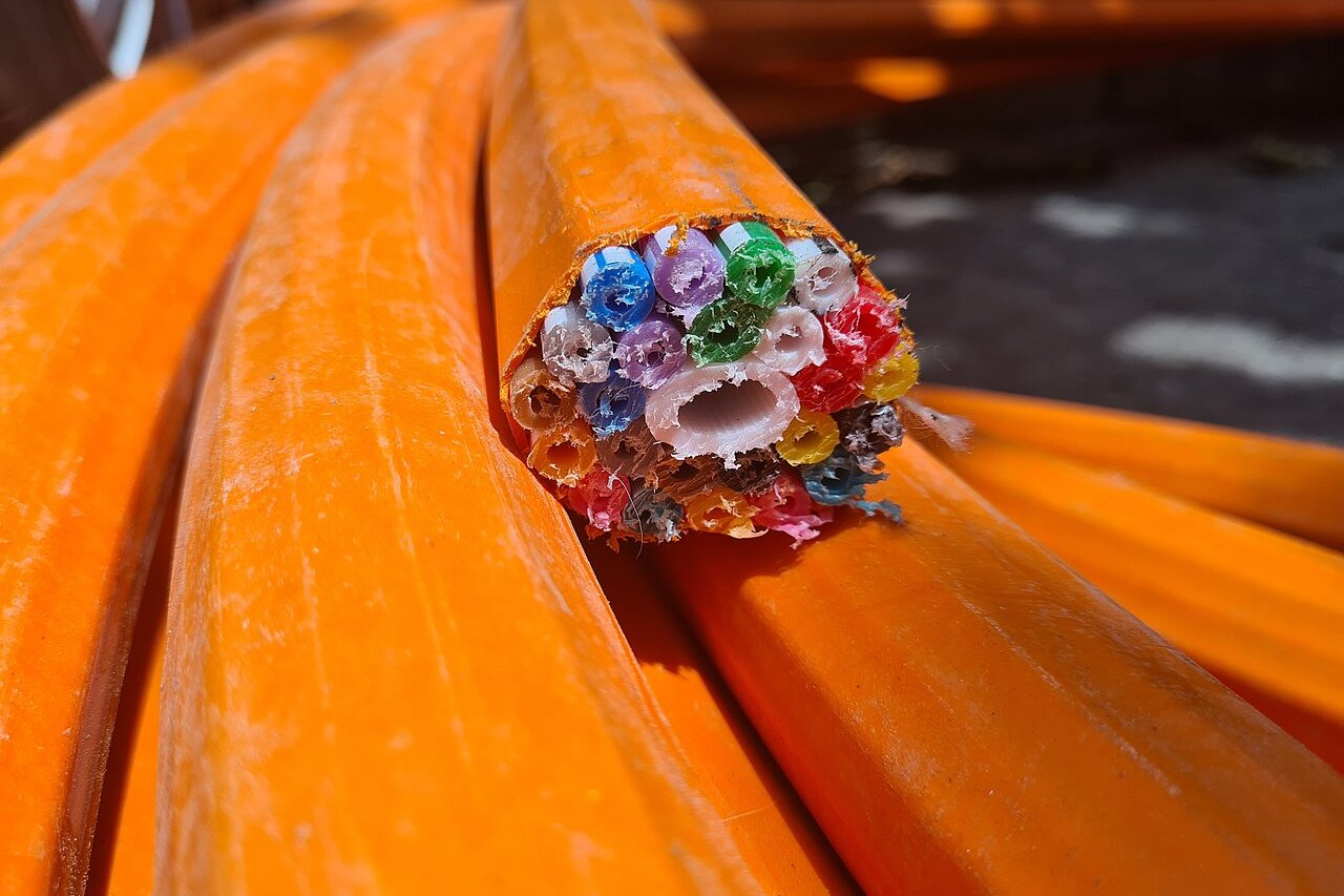 Bundles of fibre optic cabling routed along a tray