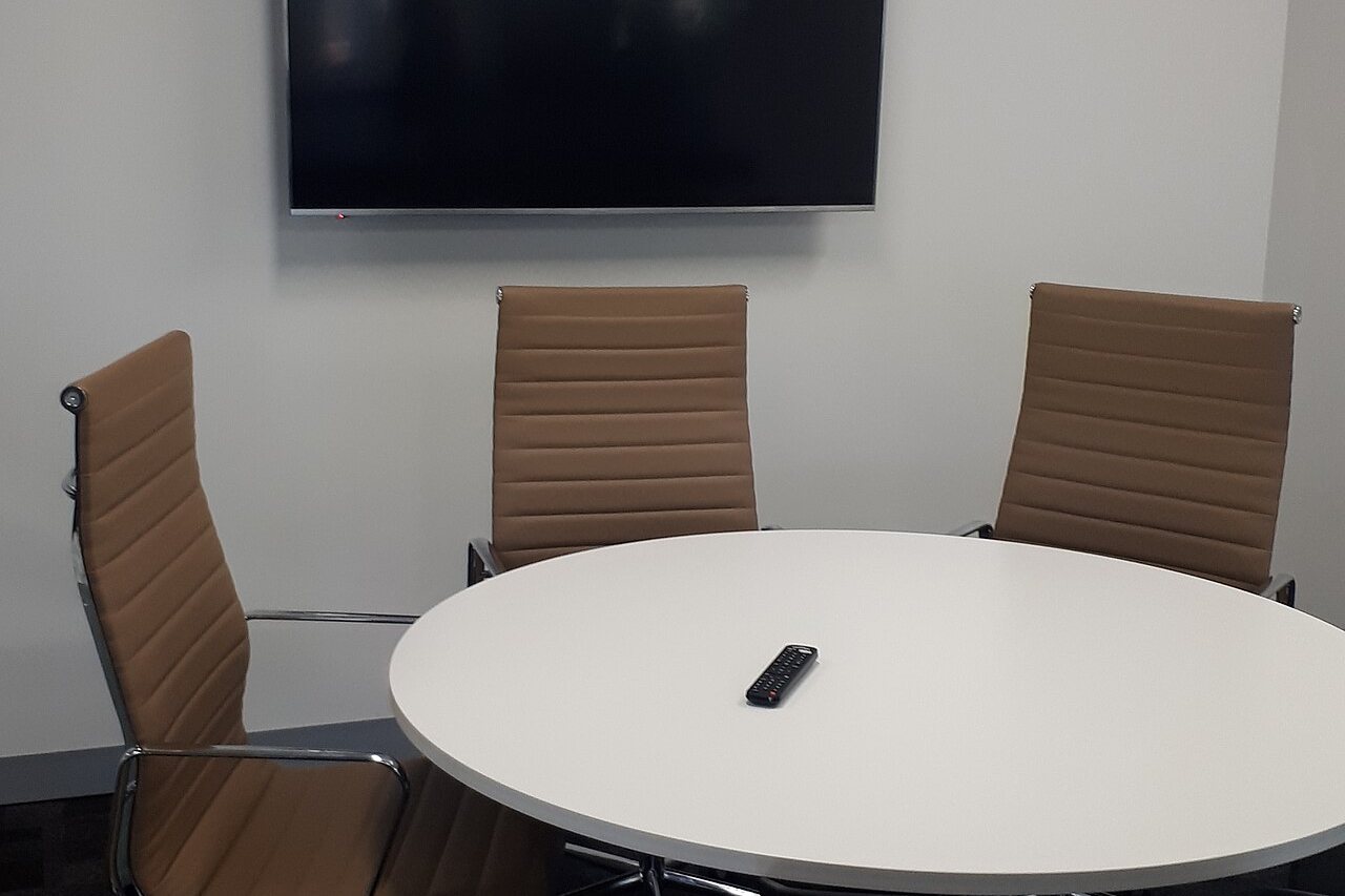 A quiet meeting room with table, chairs and daylight